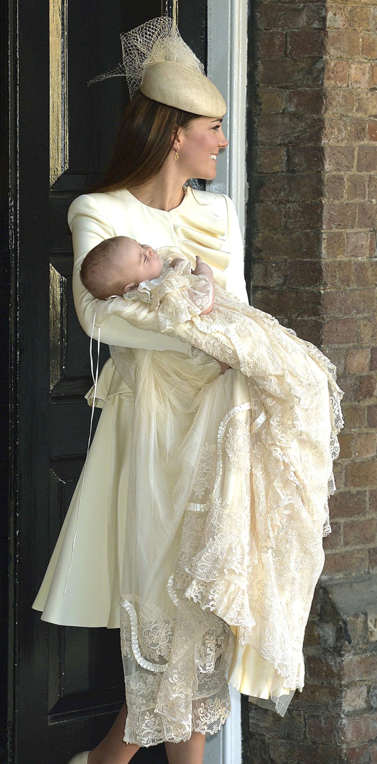 Image: Britain's Catherine, Duchess of Cambridge carries her son Prince George after his christening at St James's Palace in London